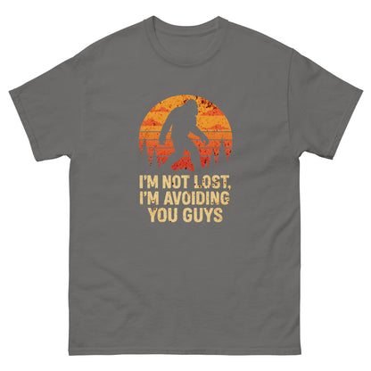 Charcoal-colored sarcastic introvert t-shirt featuring bigfoot and orange forest sunset