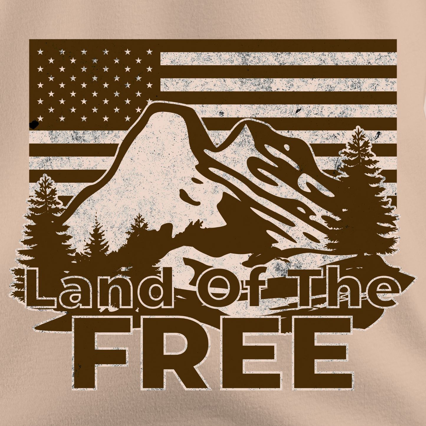 Close-up of vintage “Land of the Free” t-shirt design with mountain, pine trees, and American flag background in a rustic, outdoorsy style.
