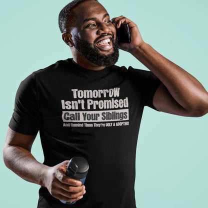 Man laughing while wearing black sibling prank shirt with “Tomorrow Isn’t Promised” funny quote
